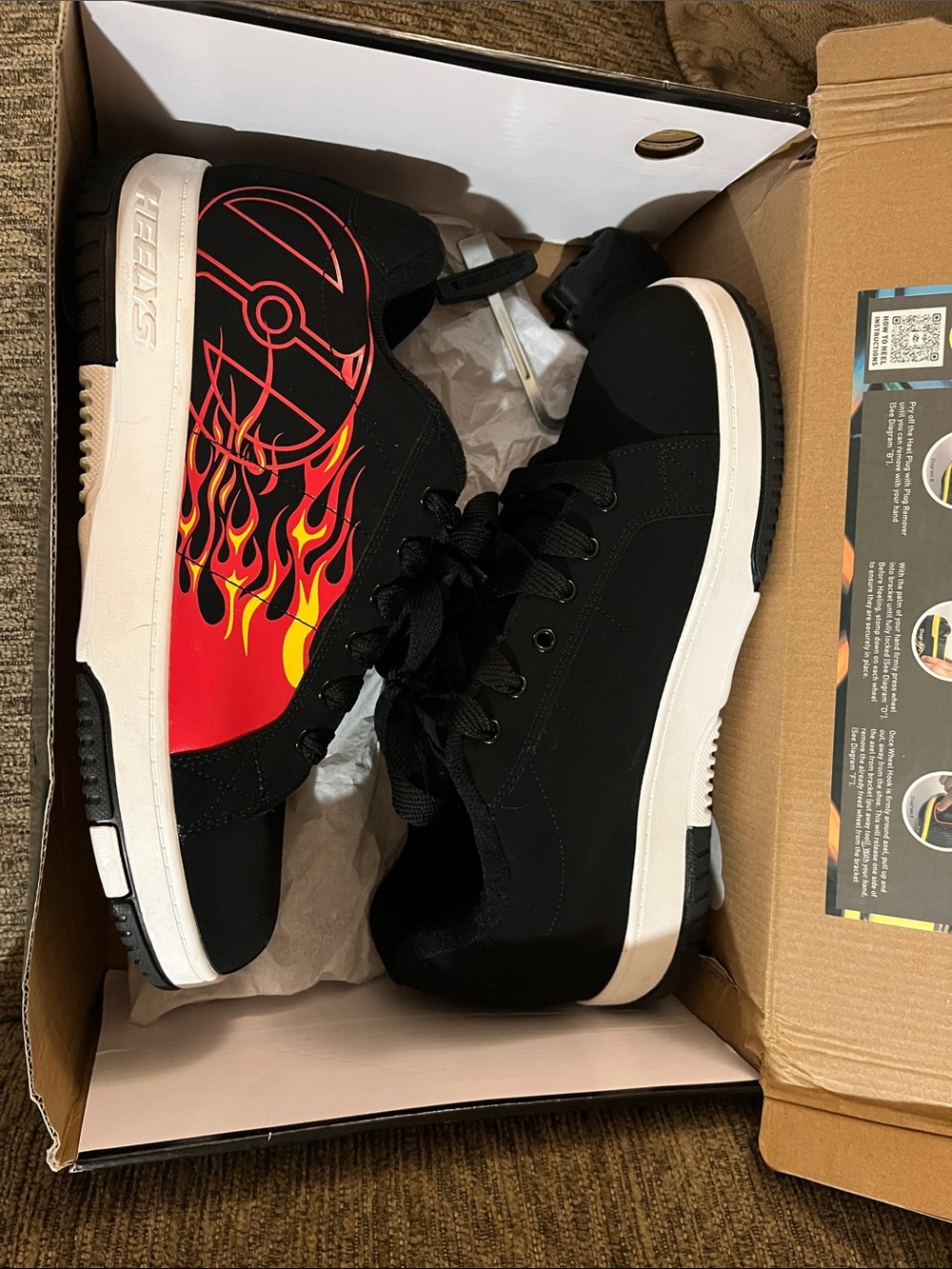 Heelys Men’s Black Sneakers with Red and Yellow Flame Graphic